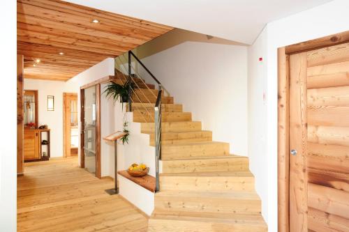 a staircase in a home with wooden floors at Hotel Naturoase Schwemmerhof in Ultimo