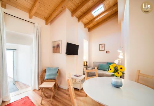 a living room with a table and a couch at Lis Apartments in Lisbon