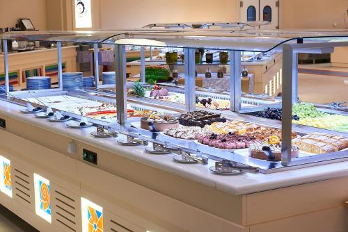 a buffet line with many different types of food at Aldemar Olympian Village in Olympia