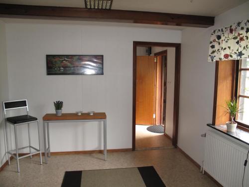 a living room with a table and a hallway at Smedsgården in Höganäs