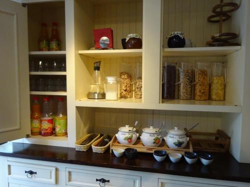 Un armario de cocina lleno de comida y bebidas. en Vintage Hotel Charivari- Sommer Hörnerbahnen kostenlos mit Restaurant, en Bolsterlang