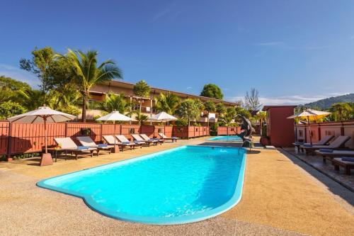 a pool at a hotel with chairs and umbrellas at Maleedee Bay Resort in Ao Nang Beach