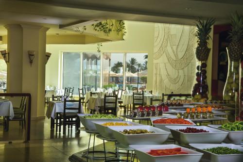 a buffet line with many plates of food in a restaurant at Movenpick Taba Resort & Spa in Taba