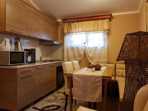 a small kitchen with a table and a microwave at Apartments Bogdanovic in Kotor