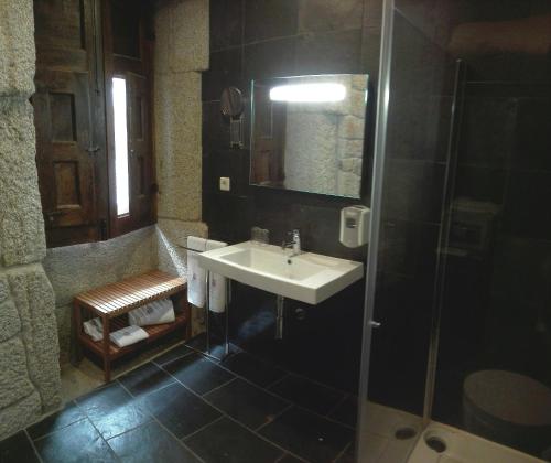a bathroom with a sink and a shower at Casa Museu in Vouzela