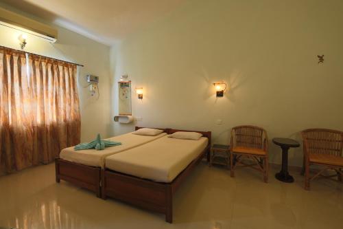 En eller flere senge i et værelse på Sea Pearl Guesthouse