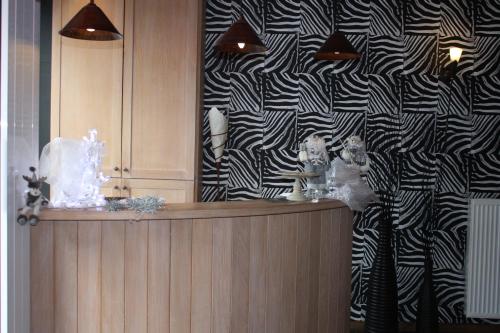 a room with a black and white patterned wall at Hotel Giorgi in Bastogne