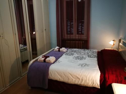a bedroom with a large bed with towels on it at Casa Bruno B&B in Mondovì