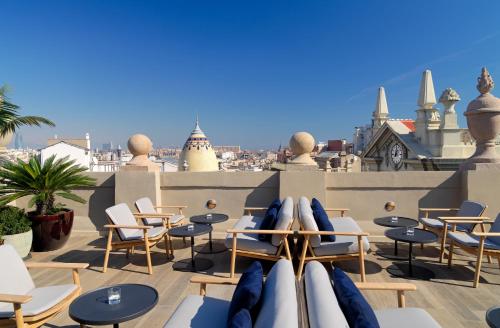 
a beach area with tables, chairs and umbrellas at H10 Madison 4* Sup in Barcelona
