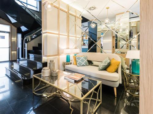 a living room with a couch and a table at Vincci Capitol in Madrid