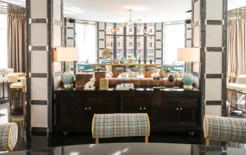 a dressing room with a mirror and two chairs at Vincci Capitol in Madrid