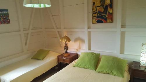Habitación con 2 camas y una lámpara en una mesa. en Villa Alizia, en Saint-François