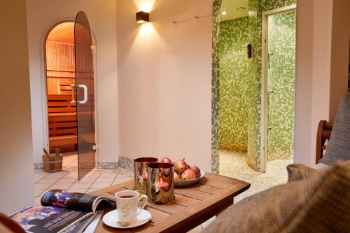 a table with a bowl of fruit and a glass shower at Alpenrose Kufstein in Kufstein