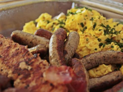 a plate of food with sausage and scrambled eggs at Bally's Dover in Dover