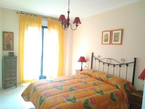 a bedroom with a bed with a colorful bedspread at L&C Codesal in Sanxenxo