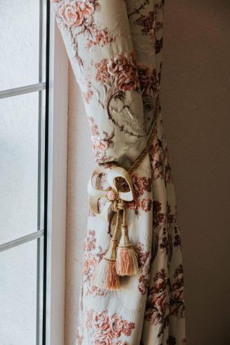 a curtain with a flower pattern on a window at Marinero Apartments in Budva