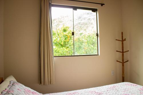 a bedroom with a bed and a window at Casa tranquila perto da Joaquina in Florianópolis