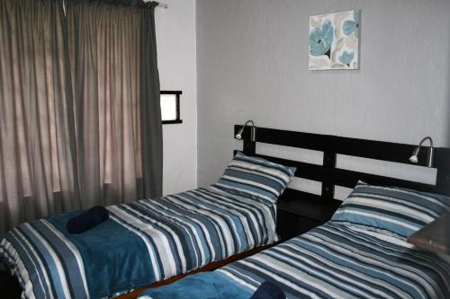 two beds sitting next to each other in a bedroom at Sabie Star in Sabie