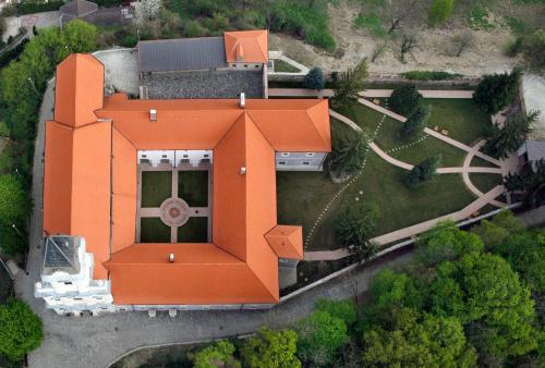 an orange house with an orange roof in a yard at Sopron Monastery Hotel in Sopron