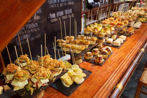 a buffet of sandwiches and other food on sticks at Pensión Txiki Polit in Zarautz