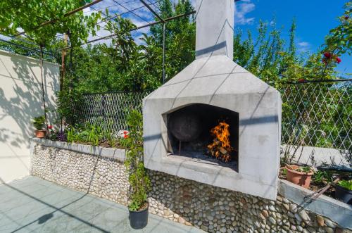 a stone oven with a fire inside of it at Villa Dalmatian Gem in Gruda