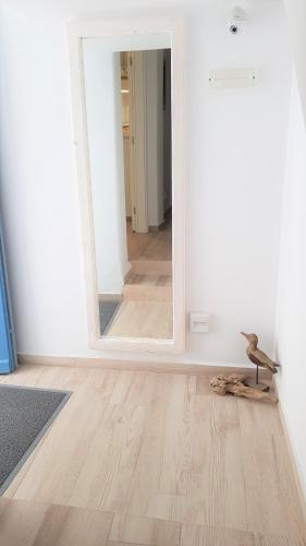an empty room with a mirror and a wooden floor at Lefteris in Mýkonos City