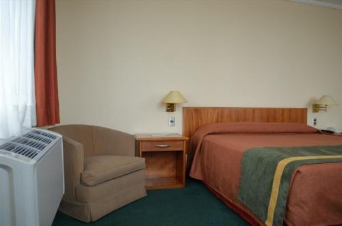 Tempat tidur dalam kamar di Hotel Diego De Almagro Talca