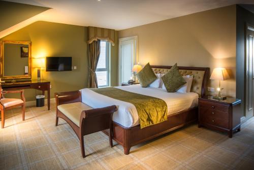a bedroom with a bed and a desk and a chair at Jackson's Hotel & Leisure Centre in Ballybofey