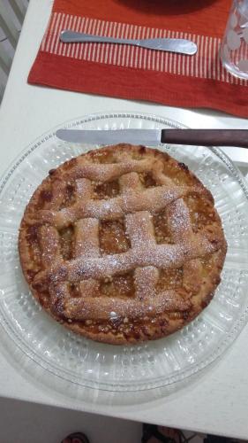 a pie sitting on a glass plate on a table at B&B Coccinelle in San Vito lo Capo