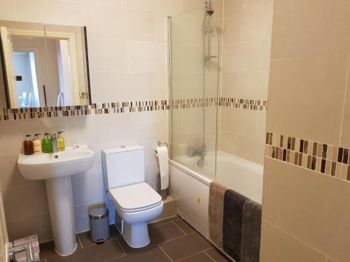 a bathroom with a toilet and a sink and a shower at Victory House in Southampton