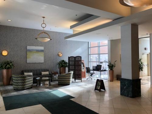 a lobby with a couch and chairs and a table at Wyndham Garden Buffalo Downtown in Buffalo