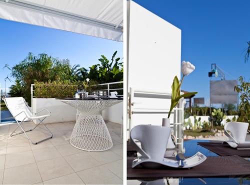 two views of a patio with a table and chairs at Abitare in Vacanza in La Caletta