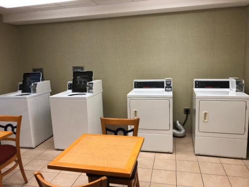a room with several washing machines and a table at Wyndham Garden Buffalo Downtown in Buffalo