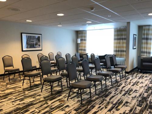 a conference room with chairs and a large window at Wyndham Garden Buffalo Downtown in Buffalo