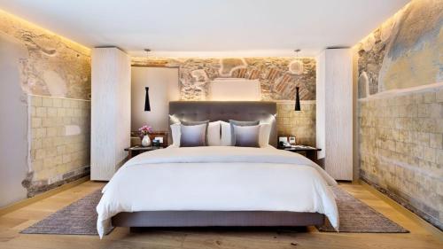 a bedroom with a large bed and a wall mural at Cartesiano Boutique & Wellness Hotel in Puebla