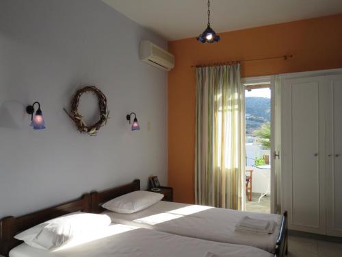 a bedroom with two beds and a large window at Korali apartments in Galissas