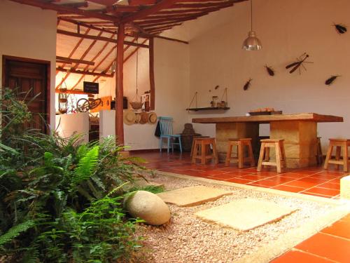 a kitchen and dining area of a house with a table at La Casa de Hercilia Boutique in Barichara