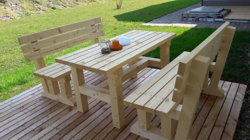 a wooden picnic table and bench on a deck at Ötscherblick Fam Winter in Frankenfels