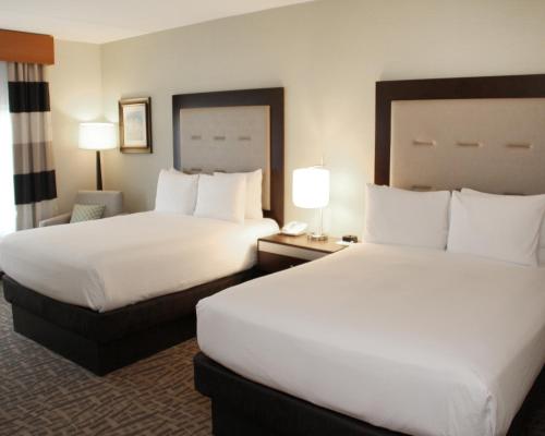 a hotel room with two beds and two lamps at Wyndham Garden Buffalo Downtown in Buffalo