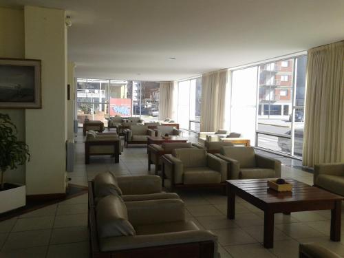 a waiting room with couches and tables and a large window at Edificio Playa Club in Miramar