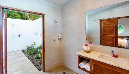 a bathroom with a sink and a shower at The Remote Resort in Nawi