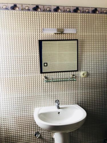a bathroom with a sink and a mirror on the wall at El Muniria in Tangier