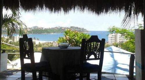 a table and chairs with a view of the ocean at Casa Artista in Manzanillo