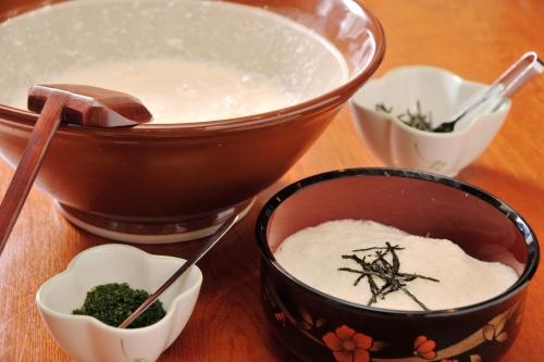 a bowl of rice and a bowl of broccoli at Matsumoto Tourist Hotel in Matsumoto