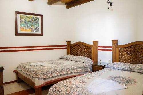 A bed or beds in a room at MESÓN DE LOS ÁNGELES