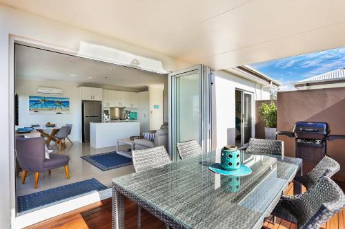 a living room with a glass table and chairs at Casa del Sol in Sunrise Beach