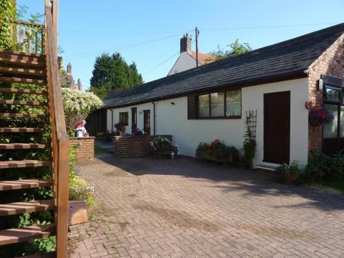 a house with a brick driveway in front of it at RolandsCroft Guest House in Pontefract