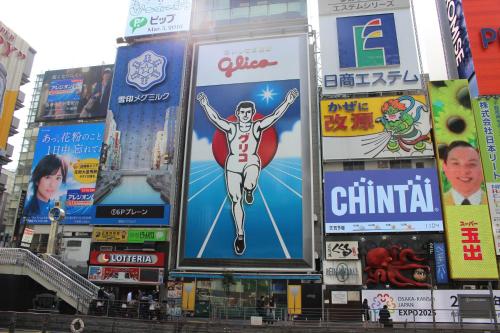 a group of signs on the side of a building at Hotel Sunplaza 2 in Osaka