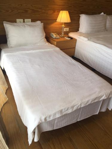a large white bed in a hotel room at Island Paradise Resort Club in Koror