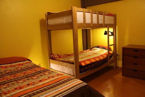 a bedroom with two bunk beds and a bed at Kame House hostel in Huaraz